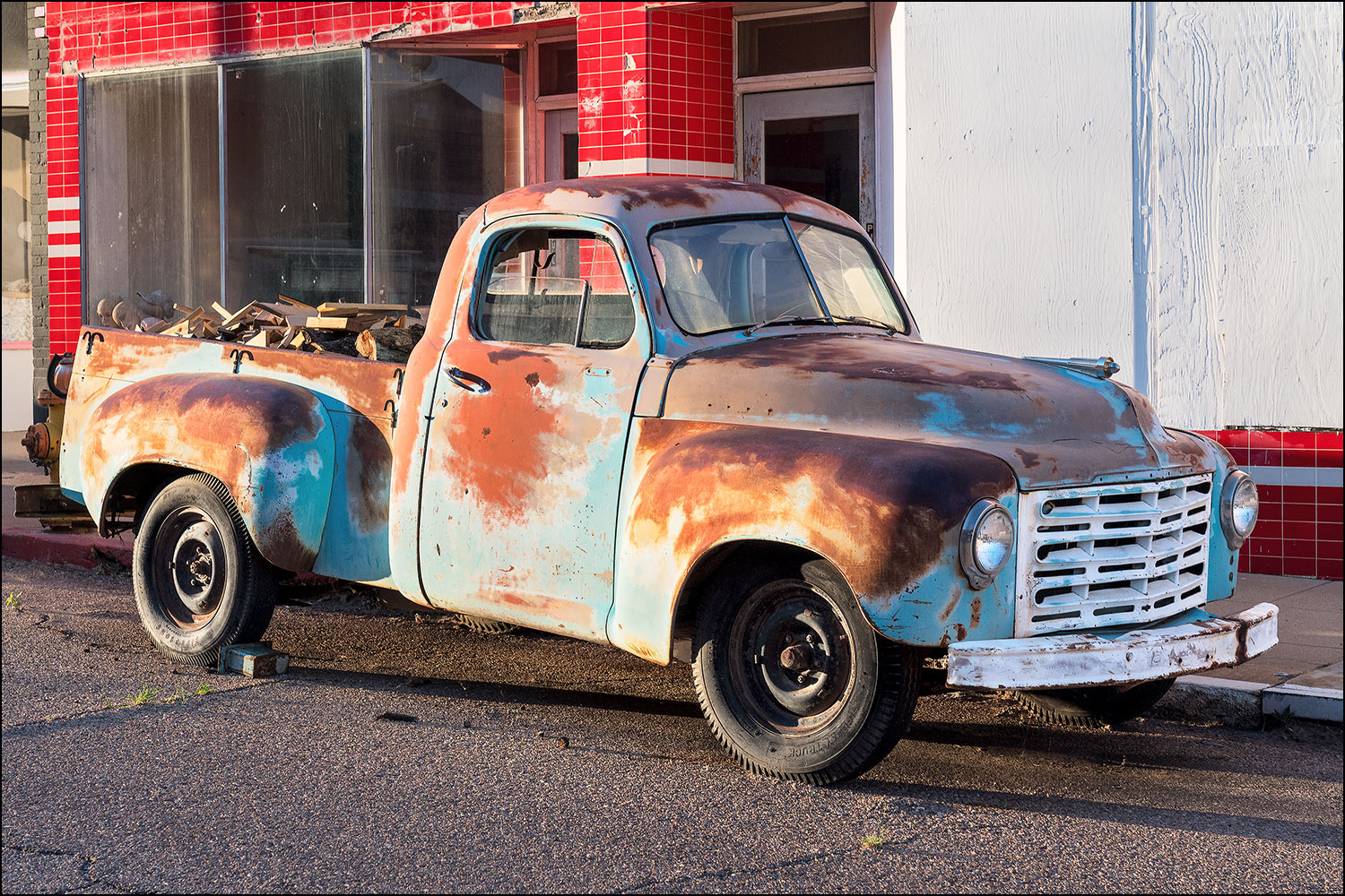 Classic rusty truck hauling firewood